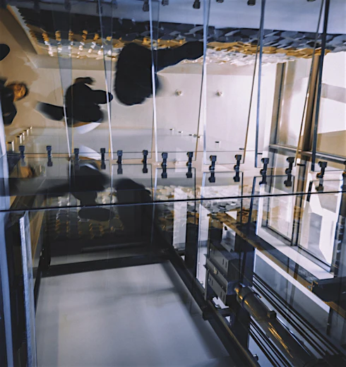 Motion blur of people walking on transparent glass spiral staircase in futuristic building on a contemporary office