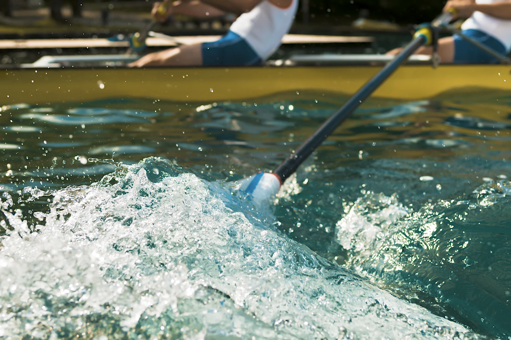 Oar splashing water in lake.
